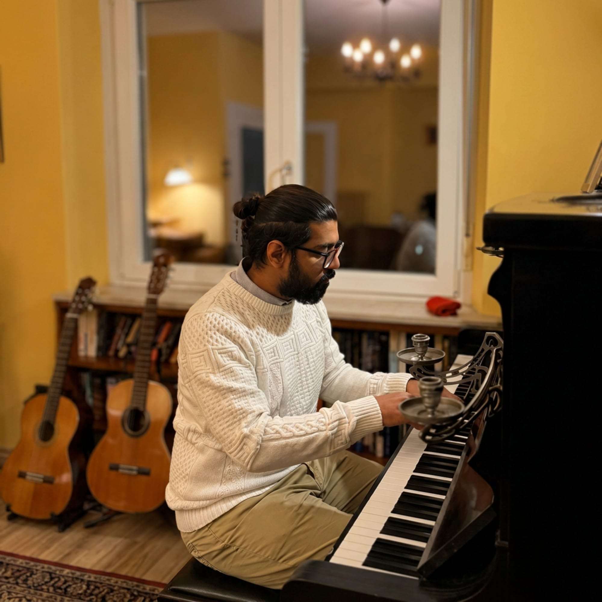 Khandaker Rahin playing an upright piano at home.